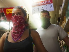 Lucia robbing a store with a guy in the Grand Theft Auto VI game