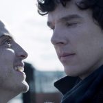 Moriarty (Andrew Scott) smiling at a serious Sherlock (Benedict Cumberbatch) in Sherlock season 2 episode The Reichenbach Fall