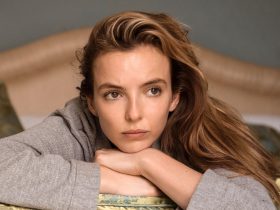 Jodie Comer as Villanelle lying on a bed in Killing Eve