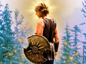 Walker Scobell as Percy Jackson holding a shield with a background featuring trees