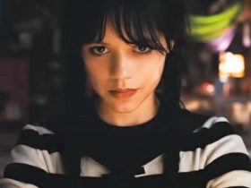 Jenna Ortega as Wednesday Addams wearing a striped shirt and smirking