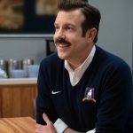 Ted Lasso (Jason Sudeikis) sits at his desk in Ted Lasso