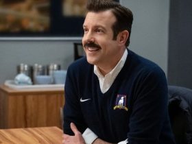 Ted Lasso (Jason Sudeikis) sits at his desk in Ted Lasso