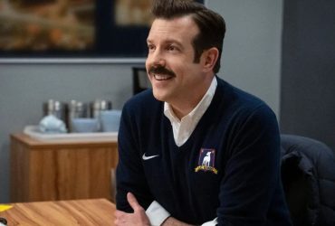 Ted Lasso (Jason Sudeikis) sits at his desk in Ted Lasso